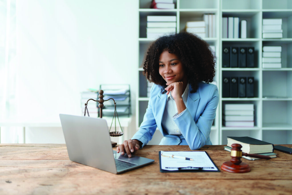 A young women African American lawyer lawsuit studying cases for clients in a law firm to fight against their parties in the courts. law and attorney concepts.