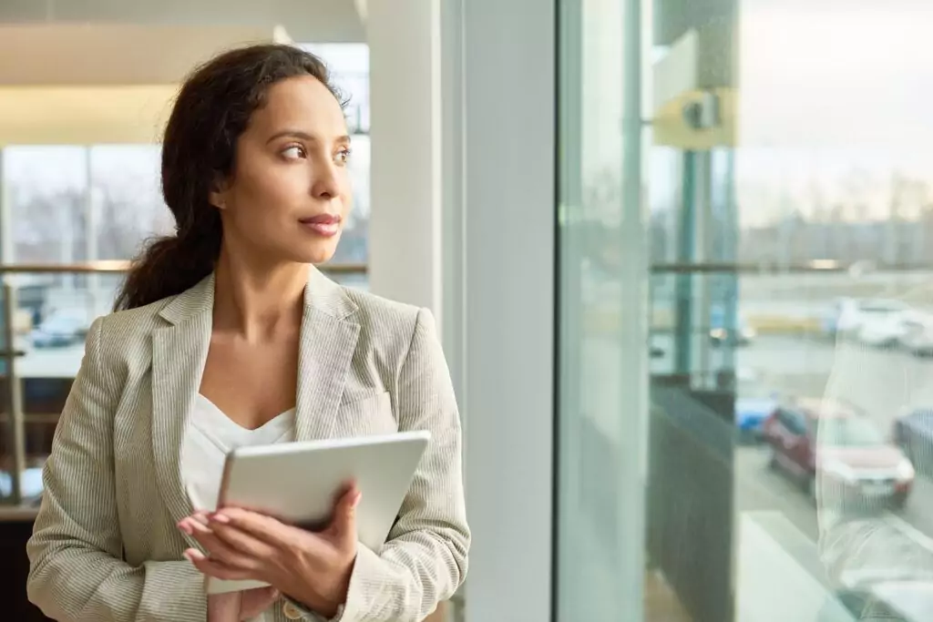 Mixed Race Businesswoman Looking out Window