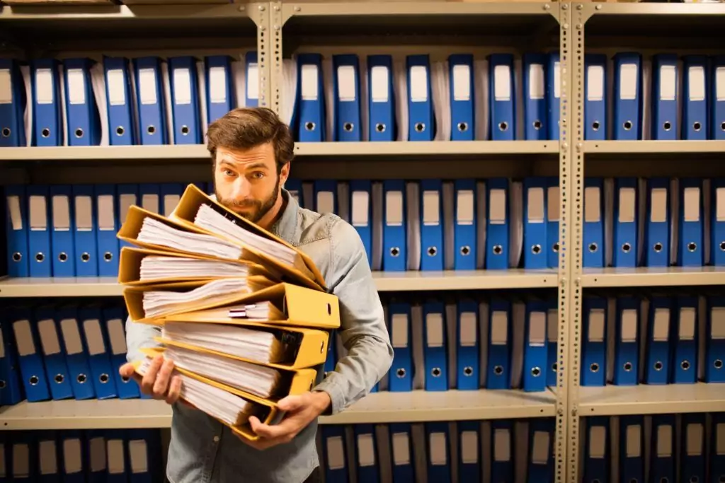 bigstock Businessman holding stack of f 186047587