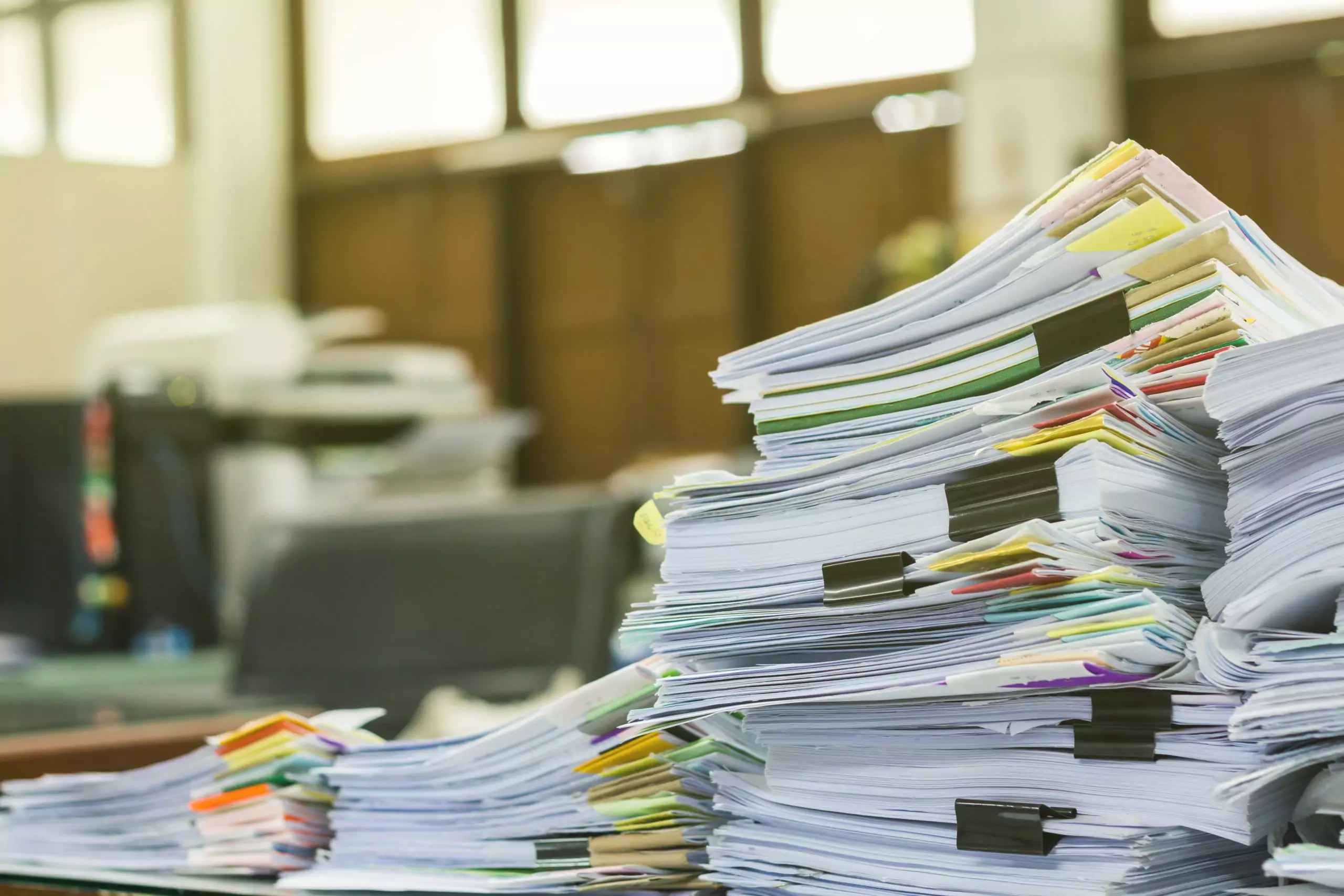 Pile of documents on desk at workplace