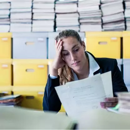 woman at the desk looking over files